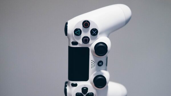 white Sony PS4 DualShock controller over person's palm
