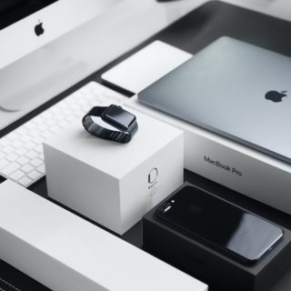 space black case Apple Watch, silver MacBook Pro, jet black iPhone 7 Plus, and silver iMac with corresponding boxes