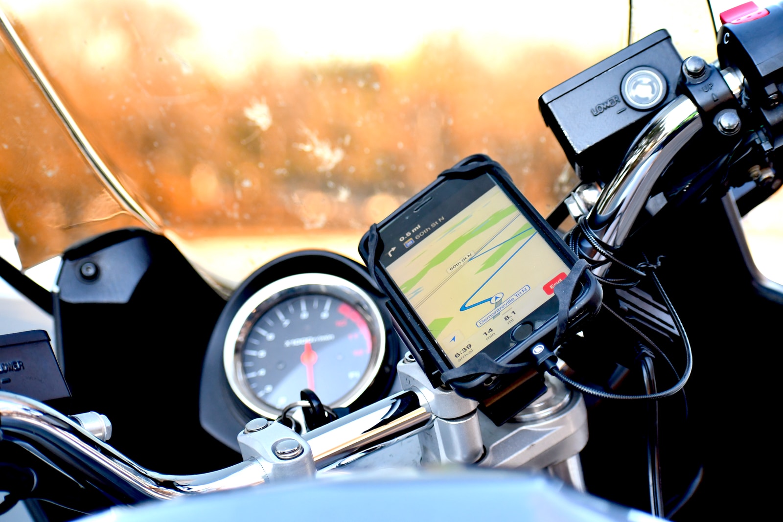 black android smartphone on car steering wheel
