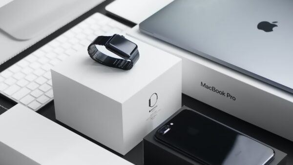 space black case Apple Watch, silver MacBook Pro, jet black iPhone 7 Plus, and silver iMac with corresponding boxes