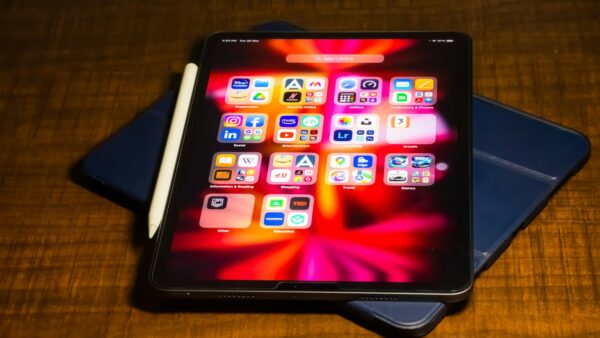 a tablet computer sitting on top of a wooden table
